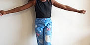 Tiana a rejoint le concours — aidez-le/la à gagner de superbes lots ! child, girl, curly_hair, black_top, blue_jeans, butterfly_patches, barefoot, posing, indoor, wooden_floor, wall, casual_clothing, playful, young, standing, balance, fashion, cute, portrait, expression