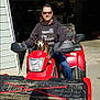 Bubba joined the competition — help win amazing prizes! person, dog, atv, outdoor, vehicle, sunglasses, casual_clothing, sunlight, garage, red, smiling, pet, animal, transportation, recreational_vehicle, companion, leisure, friendly, daytime, expression