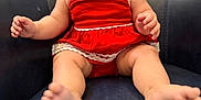 Aria joined the competition — help win amazing prizes! baby, child, red_dress, smiling, happy, sitting, couch, leather, blue, face, hands, feet, indoors, cute, infant, person, young_child, portrait, expression, skin