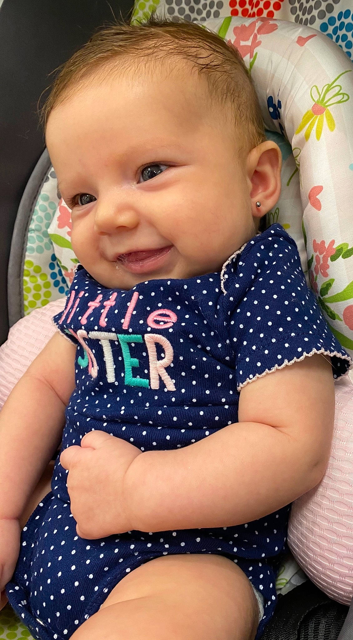 Hazel is registered to the contest to win money with this photo: baby, baby_toddler_clothing, cheek, child, cool, electric_blue, eye, finger, fun, grass, happy, human_body, iris, neck, pattern, person, product, skin, sleeve, smile