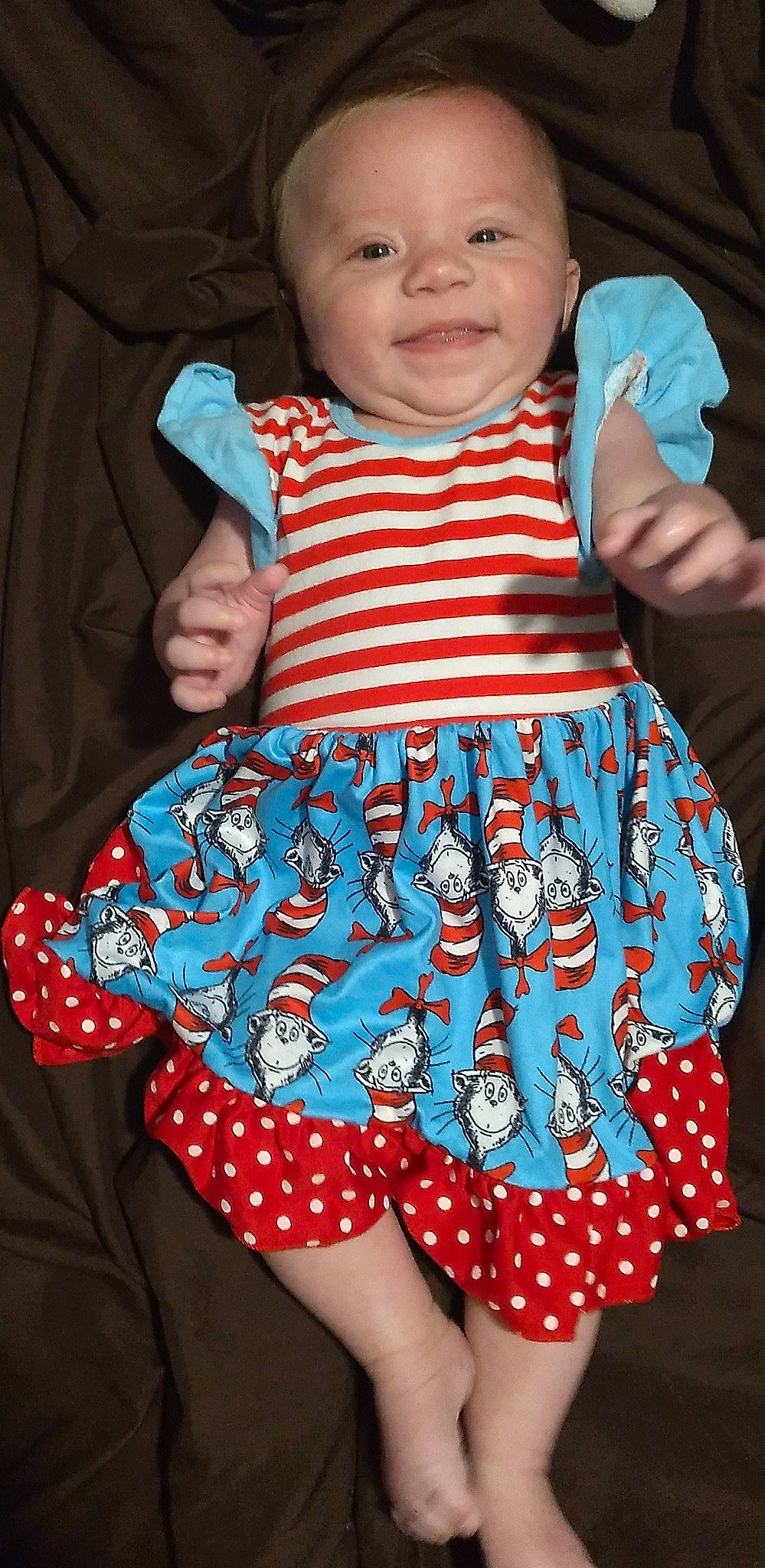 Karma is registered to the contest to win money with this photo: azure, baby, baby_toddler_clothing, blue, day_dress, electric_blue, finger, gesture, hand, happy, joy, one_piece_garment, person, pink, product, red, sleeve, standing, t_shirt, textile