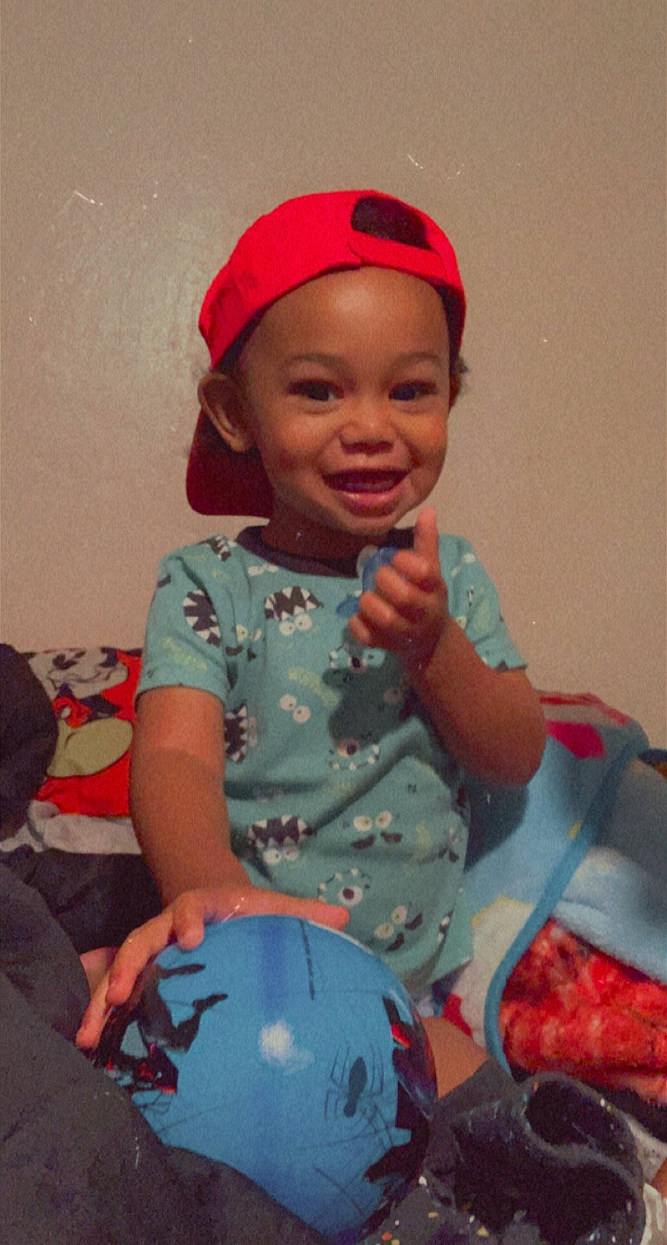 Zeus is registered to the contest to win money with this photo: baby, baby_toddler_clothing, cheek, face, finger, happy, head, headgear, headwear, human_body, joy, lip, mouth, nose, organ, person, pink, skin, sleeve, smile