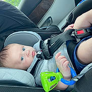 Matthew joined the competition — help win amazing prizes! baby, car_seat, child, blue_eyes, toy, car_interior, seatbelt, infant, clothing, hand, face, safety, window, daylight, cute, person, seat, vehicle, skin, closeup