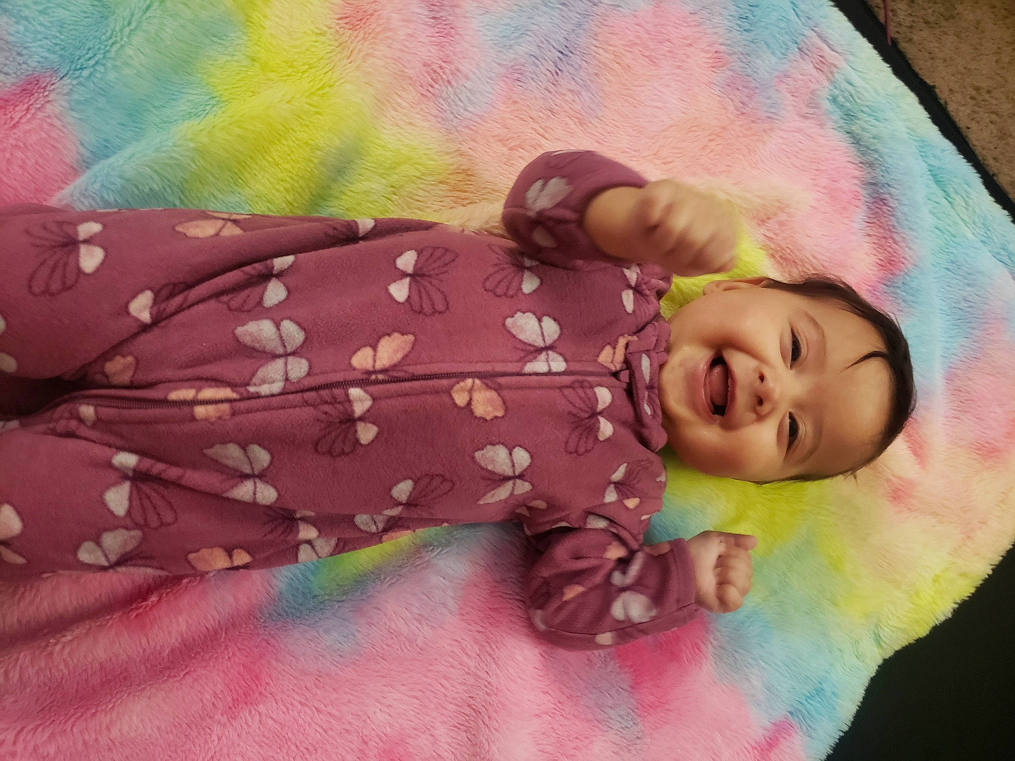 Naomie is registered to the contest to win money with this photo: baby, baby_products, baby_toddler_clothing, cheek, child, grass, happy, joy, linens, magenta, pattern, peach, person, pink, purple, skin, sleeve, smile, toddler, violet