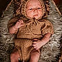 baby, infant, knitted_clothing, lion_costume, basket, fur_blanket, cozy, portrait, cute, soft_lighting, indoors, newborn, baby_legs, baby_hands, headgear, warm_colors, relaxed, child, person, closeup