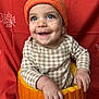 baby, child, pumpkin, hat, orange, smile, happy, knitted, autumn, fall, background, face, cute, hands, checkered_clothing, seasonal, festive, portrait, sitting, holiday
