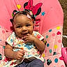 baby, carpet, child, clothing, colorful, cute, hair_clips, heart, indoor, infant, minnie_mouse, pattern, person, pink, playful, polka_dot, seat, sitting, smiling, star