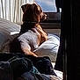 Junior joined the competition — help win amazing prizes! dog, bed, pillow, window, sunlight, indoor, animal, resting, brown_dog, collar, blanket, curtain, peaceful, relaxed, looking_out_window, furniture, home, cozy, daylight, side_view