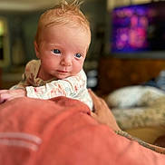Camila is registered to the contest to win money with this photo: baby, bodypart, computerhardware, couch, cushion, electronics, face, finger, furniture, hand, hardware, head, monitor, newborn, person, photography, portrait, quilt, screen, tv