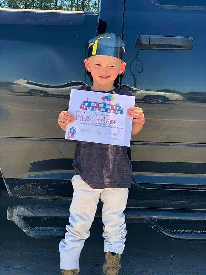 Layne is registered to the contest to win money with this photo: asphalt, automotive_design, automotive_exterior, automotive_tire, baseball_cap, bumper, child, electric_blue, family_car, fun, gas, hat, headwear, joy, motor_vehicle, person, personal_protective_equipment, recreation, sky, t_shirt