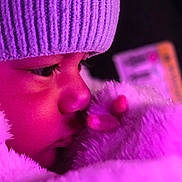 Charles Alexander joined the competition — help win amazing prizes! child, face, hat, knit_hat, blanket, plush_toy, stuffed_animal, purple_light, close_up, cozy, winter_wear, soft_texture, nose, eyelashes, warm, indoor, portrait, cute, young_child, sleepy