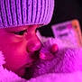 child, face, hat, knit_hat, blanket, plush_toy, stuffed_animal, purple_light, close_up, cozy, winter_wear, soft_texture, nose, eyelashes, warm, indoor, portrait, cute, young_child, sleepy