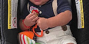 Charles Alexander joined the competition — help win amazing prizes! baby, blue_socks, car_seat, child, colorful, cute, face, footwear, hand, happy, indoor, infant, navy_shirt, person, plush_toy, seat_belt, shorts, smiling, toy, young