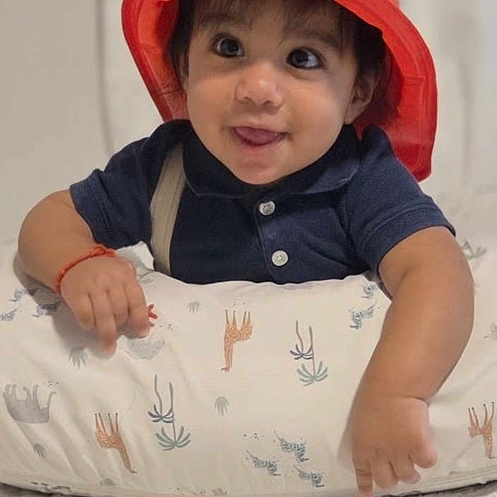 Charles Alexander joined the competition — help win amazing prizes! animal_print, baby, child, curious_eyes, cushion, cute, face, firefighter_hat, happy, indoor, infant, pale_background, person, playful, red_hat, short_sleeves, smile, tongue_out, toy_hat, young_child