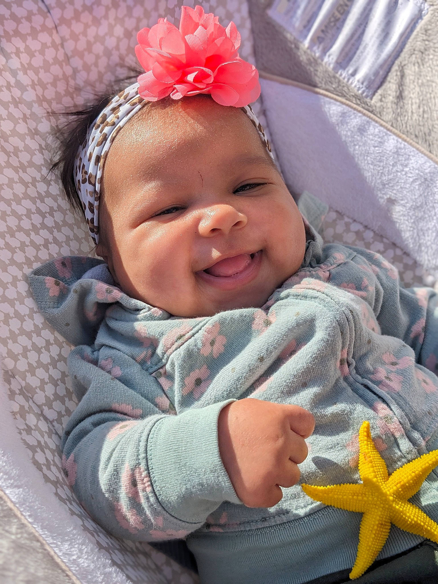 Rayanna is registered to the contest to win money with this photo: baby, baby_toddler_clothing, cheek, child, comfort, finger, grass, happy, headband, headpiece, jewellery, lip, pattern, person, pink, skin, smile, textile, thumb, toddler