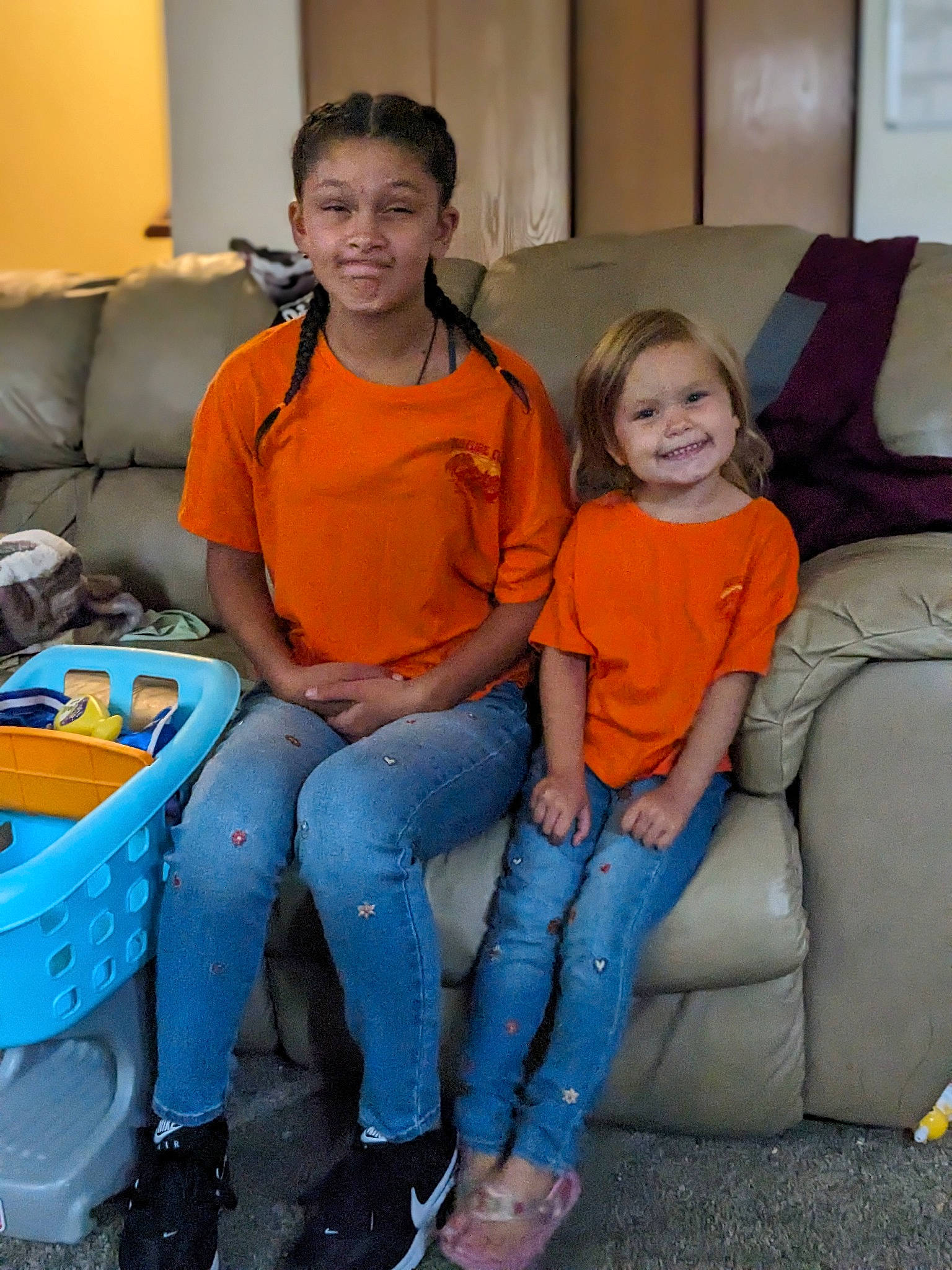 Octavia is registered to the contest to win money with this photo: child, comfort, couch, denim, electric_blue, event, fun, happy, jeans, joy, lap, leisure, luxury_vehicle, motor_vehicle, person, room, sandal, sitting, smile, t_shirt