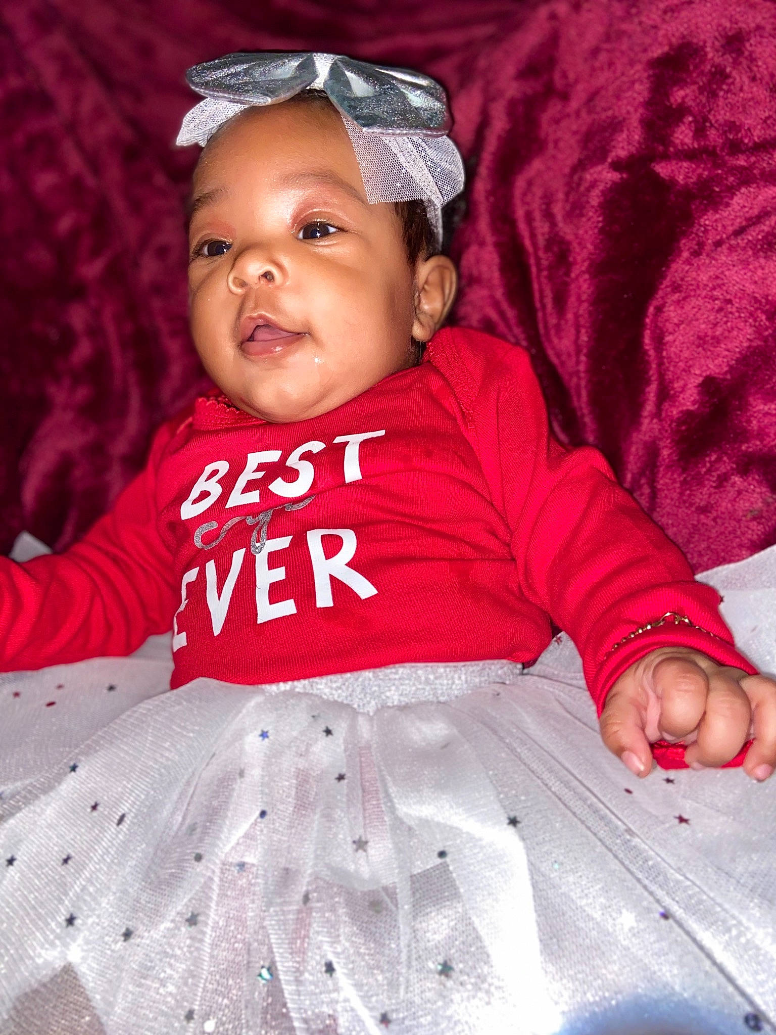 Daliylah is registered to the contest to win money with this photo: baby, baby_toddler_clothing, child, costume_accessory, day_dress, embellishment, linens, mouth, nail, nose, person, pink, textile, toddler