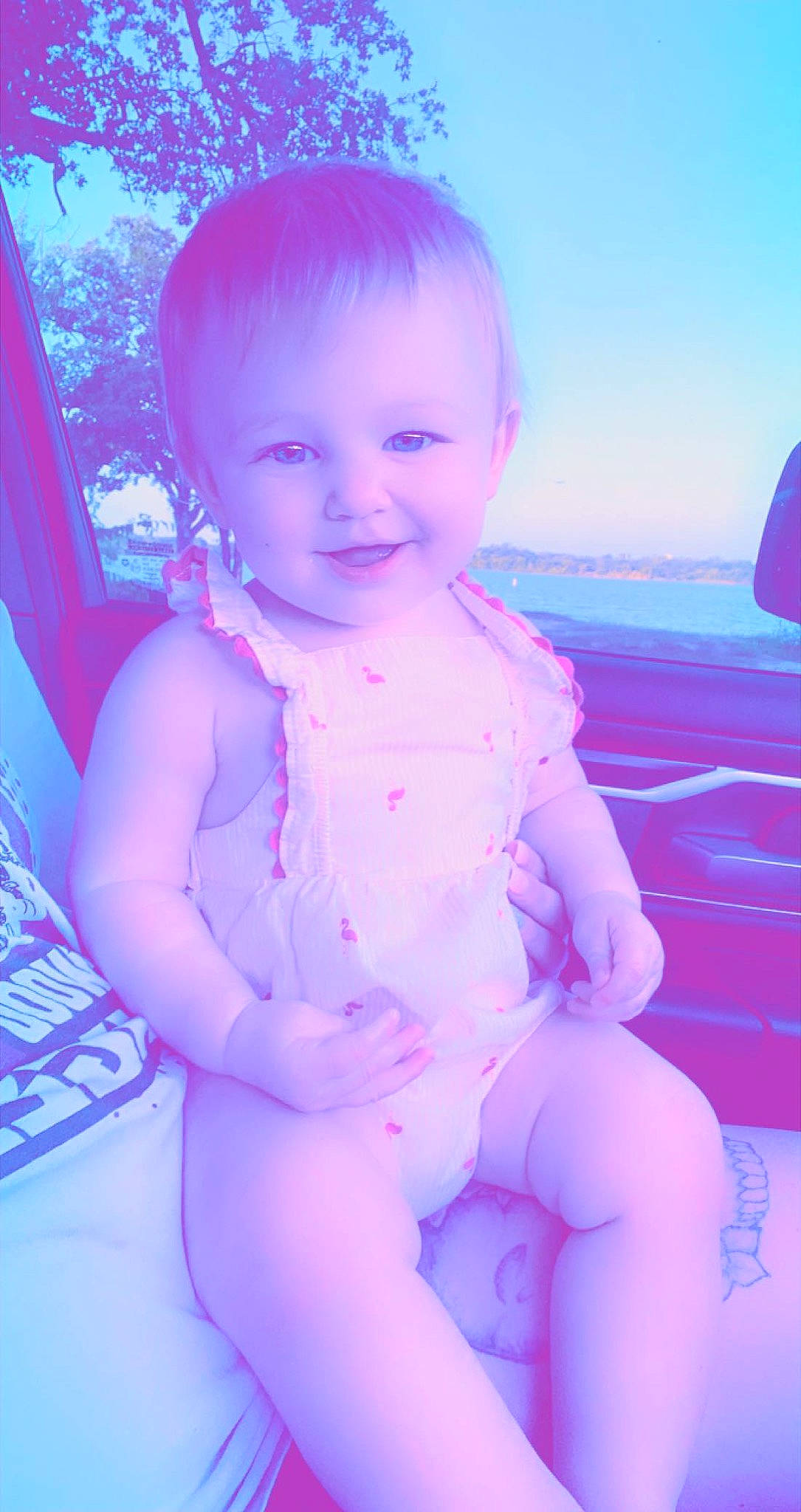 Marlowe is registered to the contest to win money with this photo: arm, azure, baby_toddler_clothing, blue, eye, face, finger, flash_photography, happy, head, human_body, iris, lip, mouth, person, pink, purple, skin, sky, smile