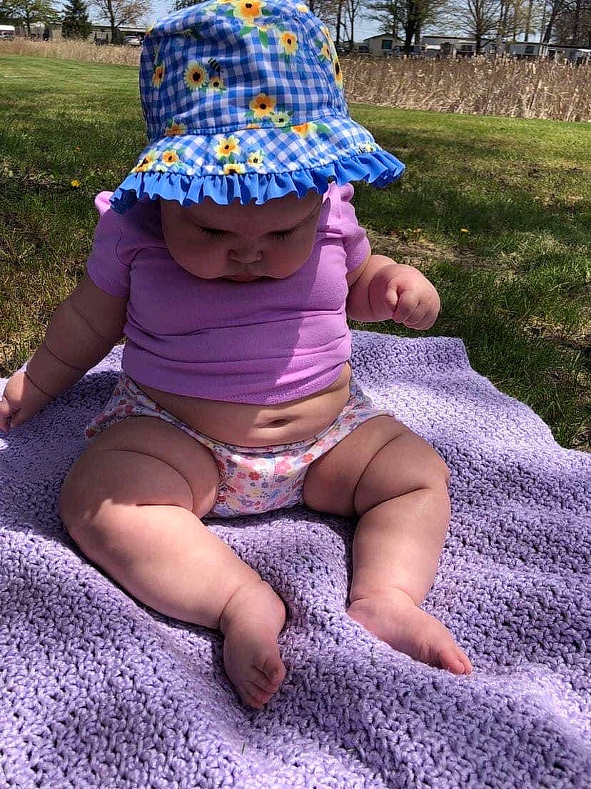 Ivanna joined the competition — help win amazing prizes! baby, baby_toddler_clothing, cap, cool, grass, hat, headgear, headwear, human_body, leaf, leg, person, photograph, pink, plant, purple, sun_hat, sunlight, thigh, toddler