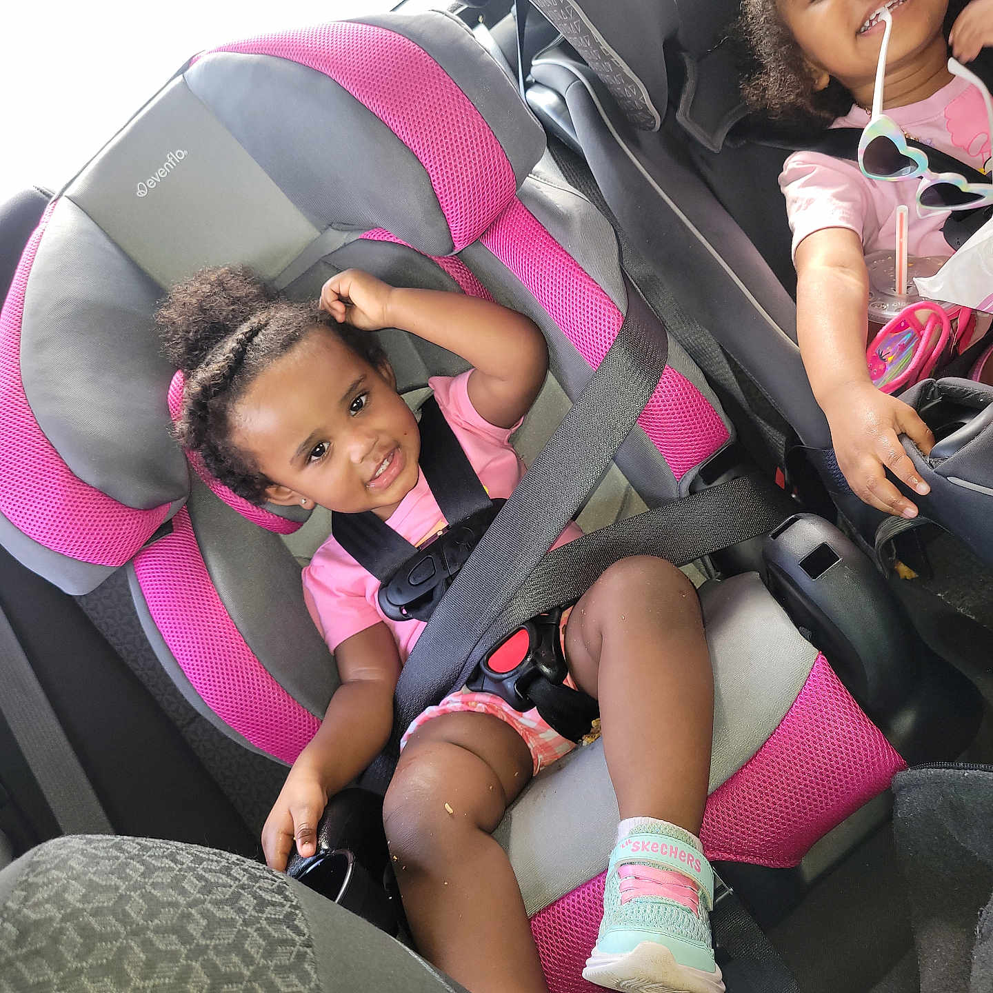 Vella joined the competition — help win amazing prizes! baby, black, car_interior, car_seat, child, clothing, cute, hair_bun, happy, person, pink, playful, safety, seat, seatbelt, shoe, smile, sunglasses, toddler, vehicle