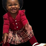 Na'Zaria joined the competition — help win amazing prizes! toddler, child, smiling, red_sweater, plaid_skirt, white_shoes, hat, happy, portrait, cute, fashion, studio, black_background, young_child, person, clothing, feet, hands, sitting, face