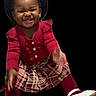 toddler, child, smiling, red_sweater, plaid_skirt, white_shoes, hat, happy, portrait, cute, fashion, studio, black_background, young_child, person, clothing, feet, hands, sitting, face