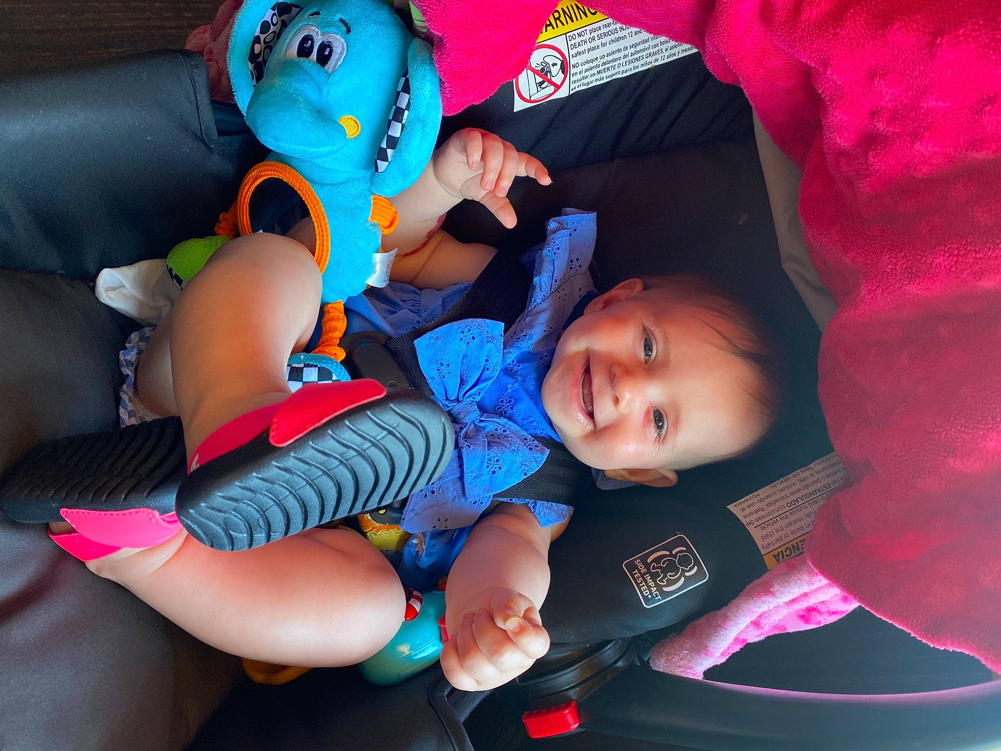 Adaline is registered to the contest to win money with this photo: arm, baby, baby_toddler_clothing, blue, cheek, comfort, finger, hand, happy, human_body, joy, leg, mouth, organ, person, pink, purple, skin, smile, textile