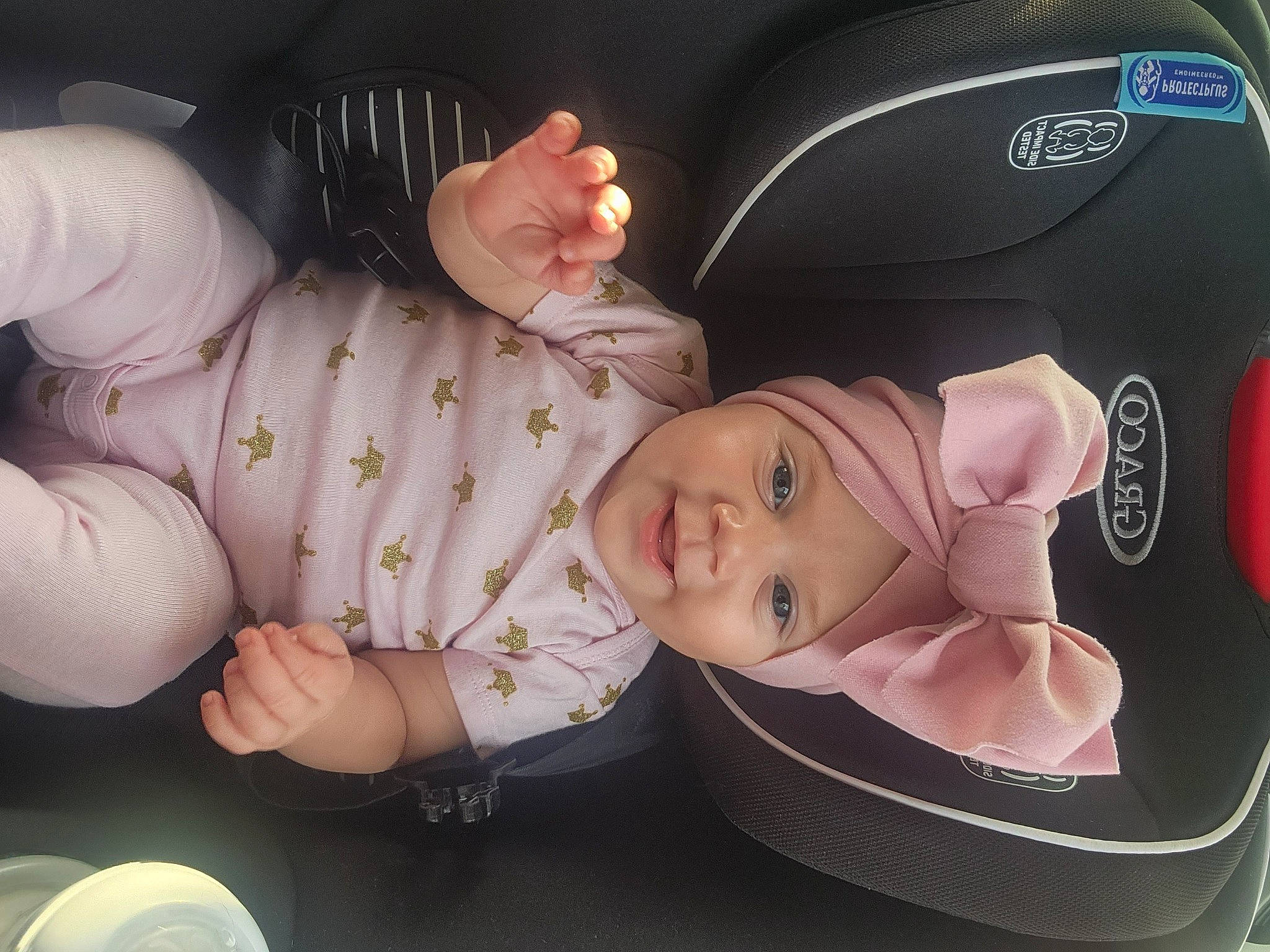 Lily joined the competition — help win amazing prizes! baby, baby_carriage, baby_in_car_seat, baby_products, baby_safety, baby_toddler_clothing, bag, car_seat, cheek, child, comfort, facial_expression, fashion_accessory, fun, gesture, headwear, people, person, sitting, thumb