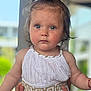 Athenais participe au concours pour gagner de l'argent avec cette photo : baby, blurred_background, child, closeup, curious_expression, cute, dress, eyes, face, gold_trim, hair, hands, indoors, person, ponytail, portrait, skin, soft_light, toddler, white_clothing