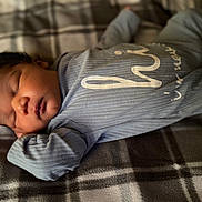 Judah joined the competition — help win amazing prizes! baby, blanket, blue_clothing, child, cozy, cute, face, head, indoors, infant, newborn, onesie, peaceful, person, plaid, portrait, resting, sleeping, soft_lighting, tiny