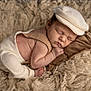Milan is registered to the contest to win money with this photo: baby, newborn, sleeping, hat, blanket, pillow, cozy, soft_texture, fur_rug, studio_photography, infant, peaceful, portrait, hand, toes, clothing, beige, neutral_tones, resting, closed_eyes