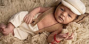 Milan joined the competition — help win amazing prizes! baby, newborn, infant, portrait, blanket, fur, hat, cap, onesie, suspenders, button, hand, feet, red_bracelet, soft_texture, cozy, studio_photography, closeup, skin, cute