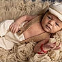 baby, newborn, infant, portrait, blanket, fur, hat, cap, onesie, suspenders, button, hand, feet, red_bracelet, soft_texture, cozy, studio_photography, closeup, skin, cute
