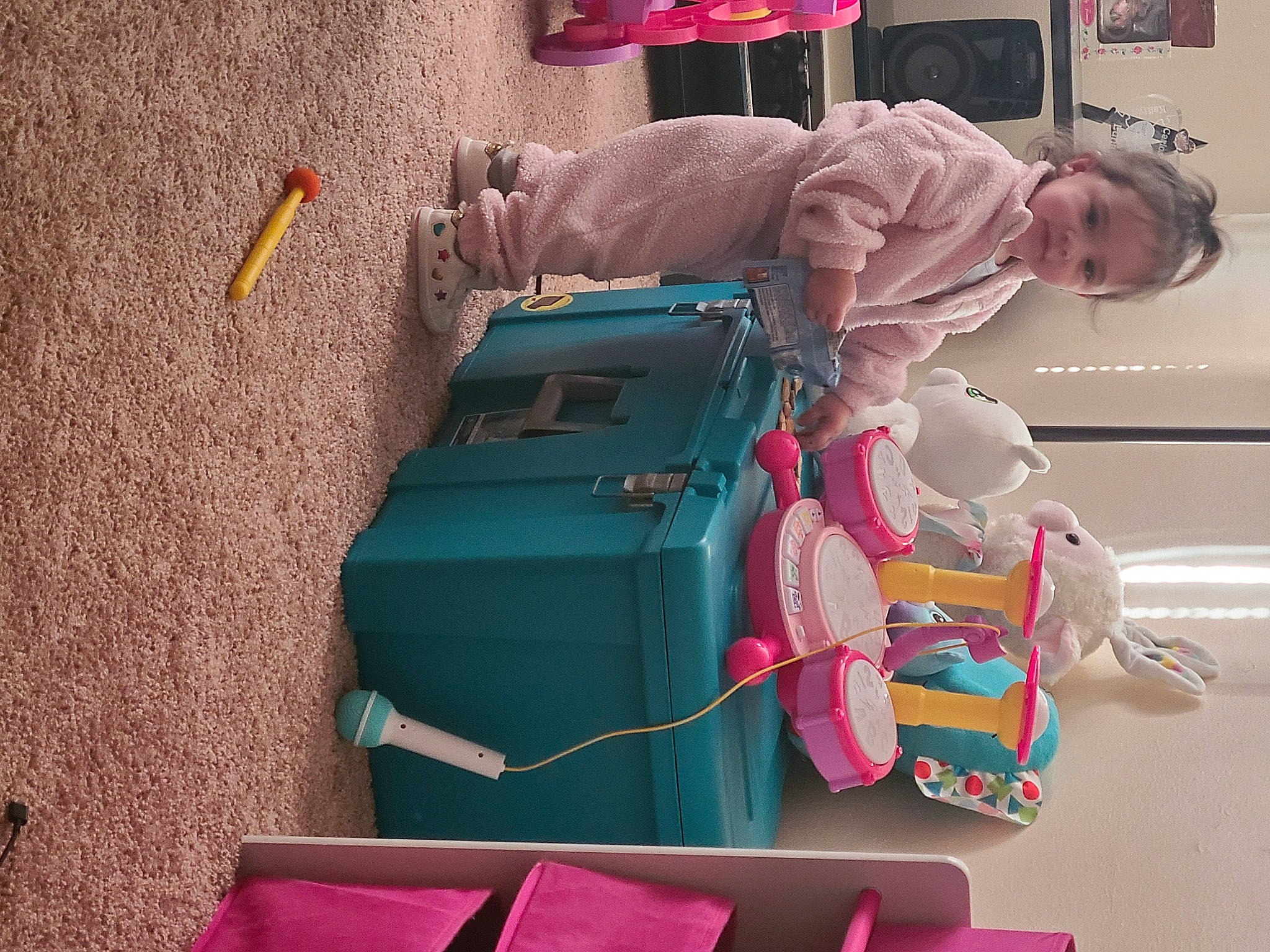 Luna is registered to the contest to win money with this photo: baby, baby_products, baby_toys, bag, baggage, child, fun, machine, magenta, mode_of_transport, motor_vehicle, person, pink, plastic, play, room, sitting, tire, toddler, travel