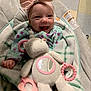accessories, baby, babylaughing, bed, blanket, cushion, face, furniture, happy, head, homedecor, laughing, newborn, person, photography, portrait, quilt, smile, towel, toy