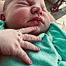 Daisy is registered to the contest to win money with this photo: newborn, baby, sleeping, infant, portrait, face, closed_eyes, peaceful, hand, gentle_touch, blanket, green_clothing, mint_green, indoor, close_up, soft_lighting, resting, parent, cozy, photography