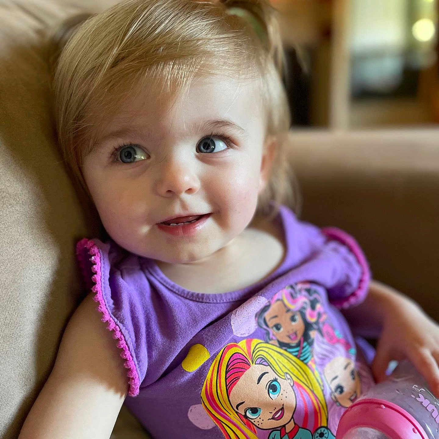Khaleesi is registered to the contest to win money with this photo: baby, blonde, bodypart, can, clothing, couch, cushion, face, finger, furniture, hair, happy, head, homedecor, person, photography, portrait, smile, t_shirt, tin