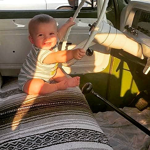 Landyn joined the competition — help win amazing prizes! automotive_exterior, baby, baby_toddler_clothing, car, car_seat, comfort, finger, hood, human_leg, leg, motor_vehicle, person, smile, steering_wheel, t_shirt, thigh, thumb, toddler, vehicle, vehicle_door