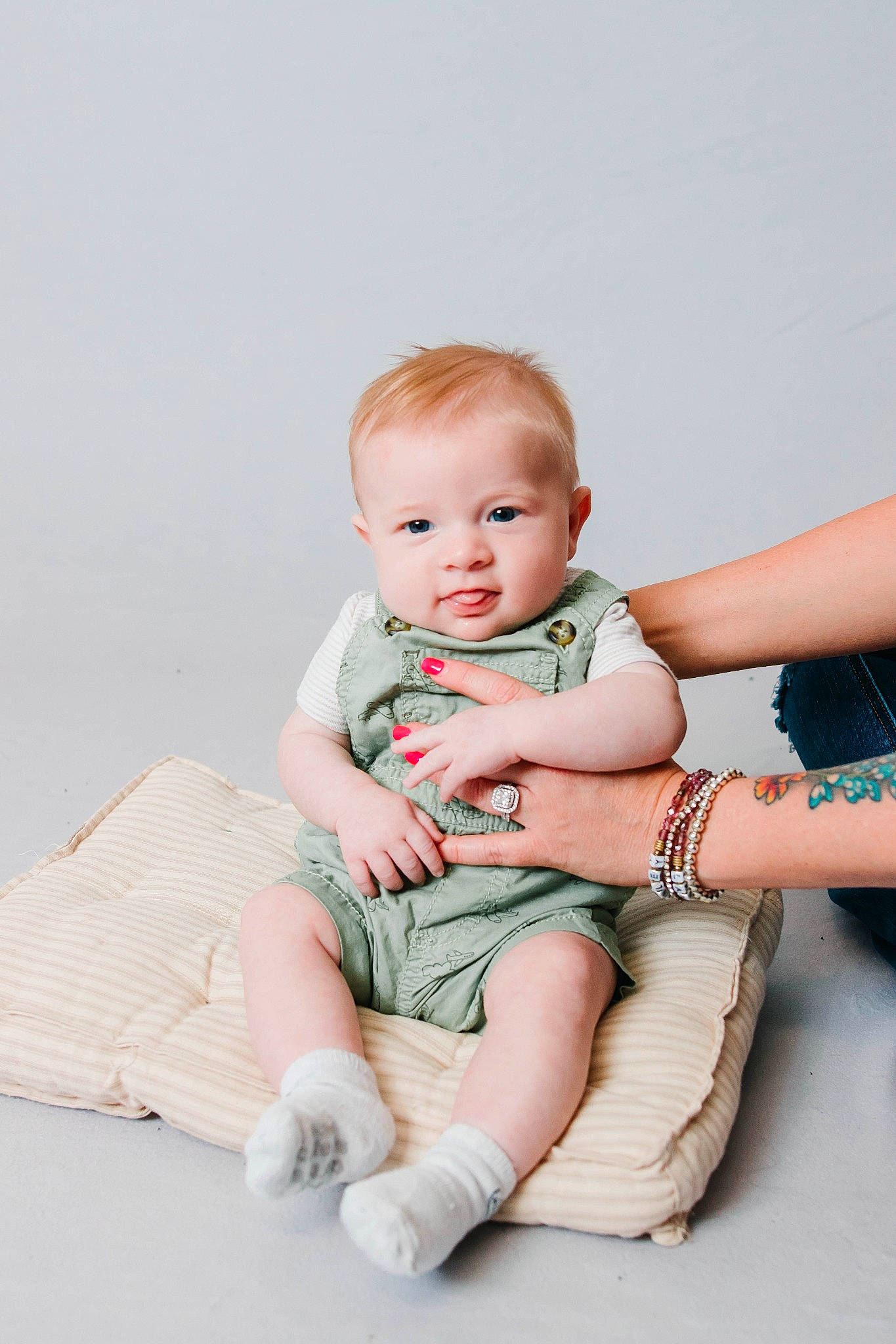 Kix is registered to the contest to win money with this photo: baby, baby_toddler_clothing, cheek, child, comfort, elbow, face, flash_photography, foot, happy, human_body, human_leg, knee, person, sitting, skin, sleeve, sock, stomach, thigh