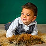Lhenno a rejoint le concours — aidez-le/la à gagner de superbes lots ! baby, child, cute, eye_contact, fur_rug, green_background, hands, happy, indoors, infant, lying_down, portrait, pose, shirt, short_hair, smile, studio, toddler, vest, wooden_floor