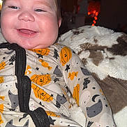 Kaysen joined the competition — help win amazing prizes! baby, child, infant, smiling, happy, portrait, indoors, blanket, onesie, pajamas, pumpkin, cat_pattern, halloween, zipper, seated, face, head, cozy, flash_photography, home