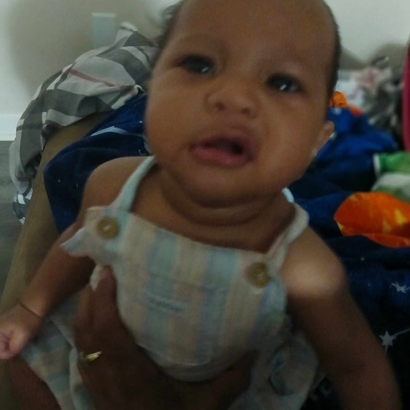 Ayonna joined the competition — help win amazing prizes! adult_hand, arm, baby, blanket, blur, casual, child, clothing, fabric, face, furniture, hand, holding, indoor, infant, person, portrait, ring, skin, striped_outfit