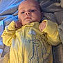 Emri joined the competition — help win amazing prizes! baby, infant, yellow_onesie, giraffe_print, blanket, cozy, sleepwear, cute, lying_down, child, portrait, indoor, soft_lighting, newborn, person, smiling, hands, face, young, relaxed
