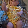 Emri joined the competition — help win amazing prizes! baby, infant, onesie, yellow_clothing, floral_pattern, blanket, bed, soft_toy, motion_blur, hand, foot, skin, person, lying_down, comfort, indoor, fabric, cute, child, sleepwear