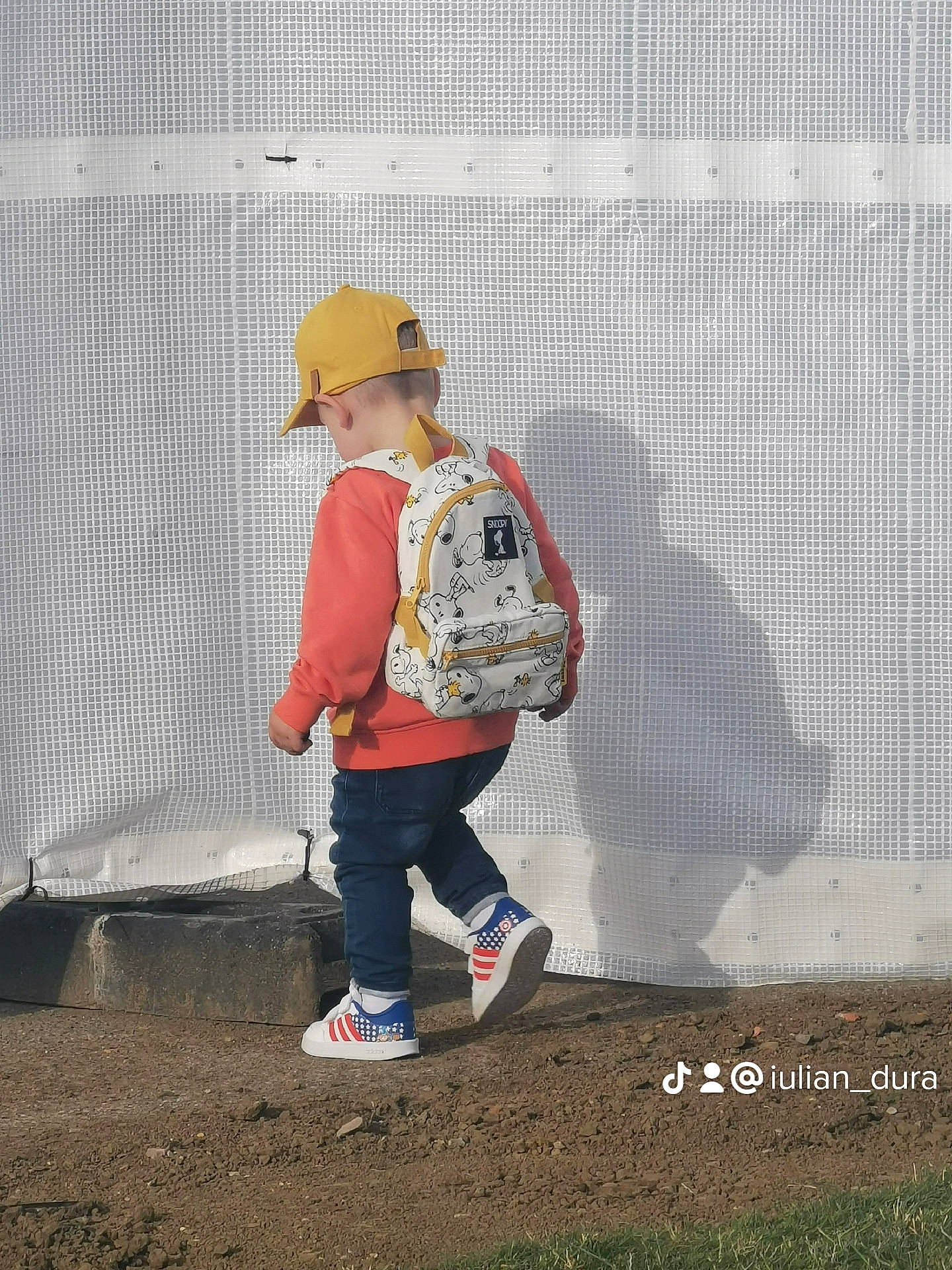 Victor is registered to the contest to win money with this photo: art, asphalt, boot, cap, carmine, fashion_accessory, font, fun, hat, headgear, landscape, luggage_and_bags, pattern, people_in_nature, person, personal_protective_equipment, player, soil, sun_hat, visual_arts