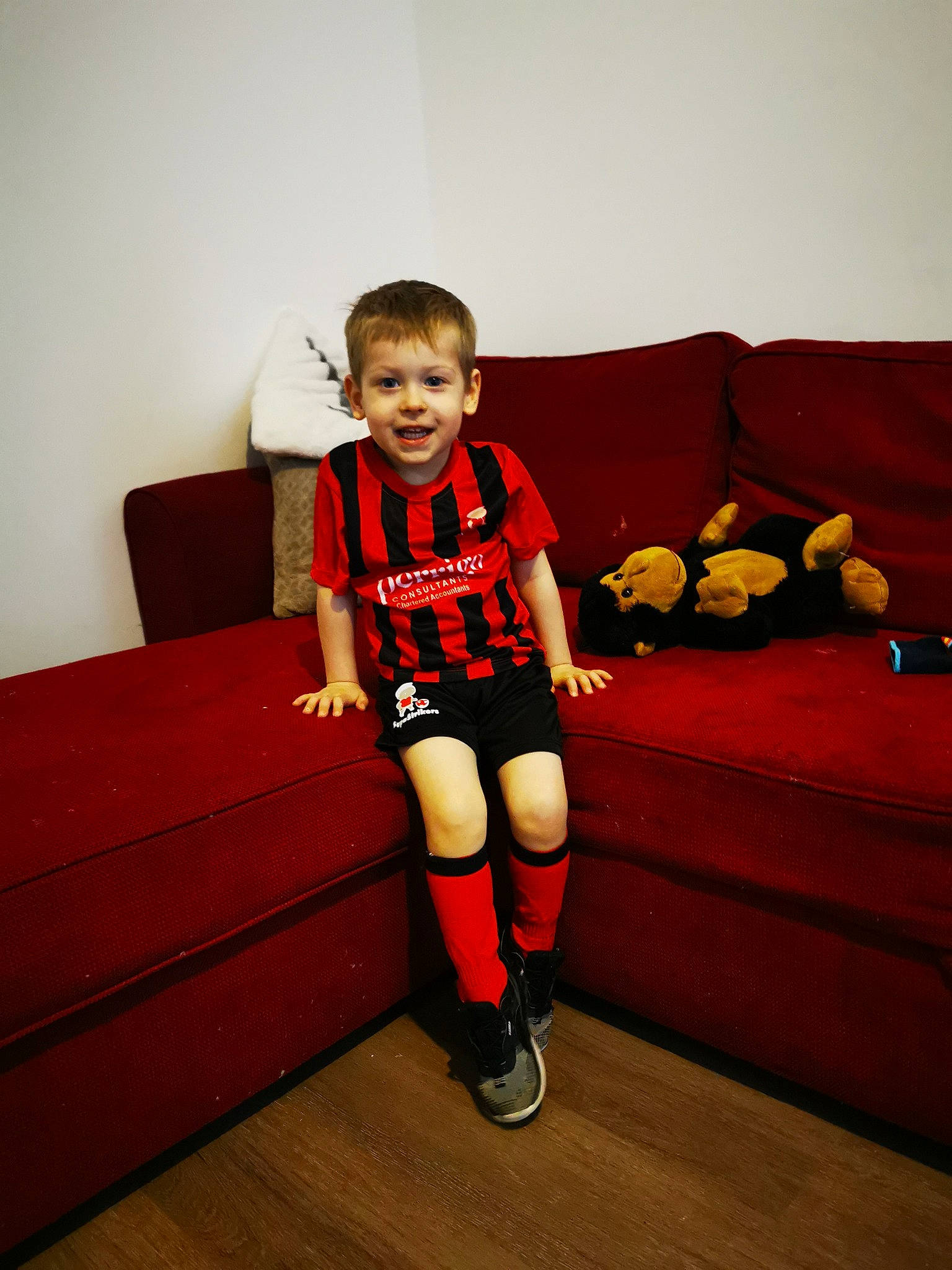 Victor joined the competition — help win amazing prizes! child, comfort, couch, flash_photography, floor, flooring, happy, hardwood, human_leg, joy, knee, orange, person, sitting, sleeve, smile, sock, sportswear, t_shirt, thigh