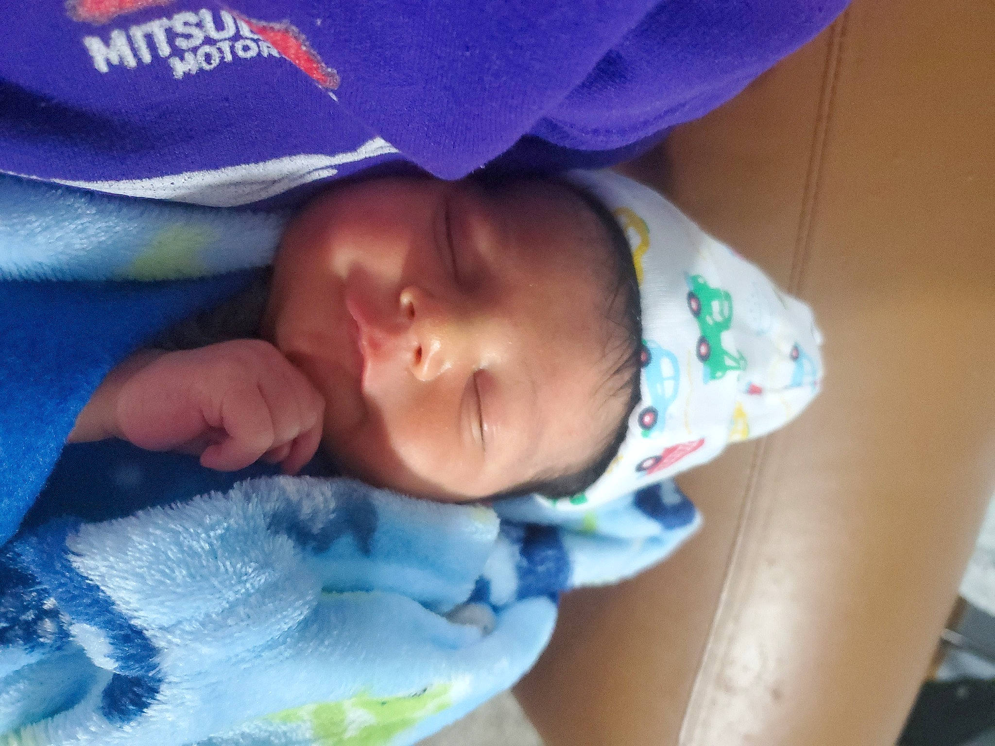 Muhammad is registered to the contest to win money with this photo: arm, baby, baby_toddler_clothing, blue, cheek, chin, eye, eyebrow, face, finger, head, headgear, human_body, iris, lip, mouth, nose, person, purple, skin