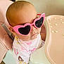baby, sunglasses, pink, heart_shaped, high_chair, infant, child, cute, fashion, apparel, person, indoor, seat, table, food, snack, portrait, playful, accessory, young