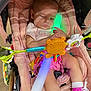 Vivian is registered to the contest to win money with this photo: baby, sleeping, stroller, pink, toy, light_stick, child, shoes, sock, cushion, hand, face, infant, cute, colorful, indoor, peaceful, small, rest, person