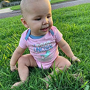 Vivian joined the competition — help win amazing prizes! baby, grass, outdoor, child, pink_onesie, sitting, smiling, face, head, sunlight, greenery, lawn, suburban, house, front_yard, nature, daylight, cute, infant, happy